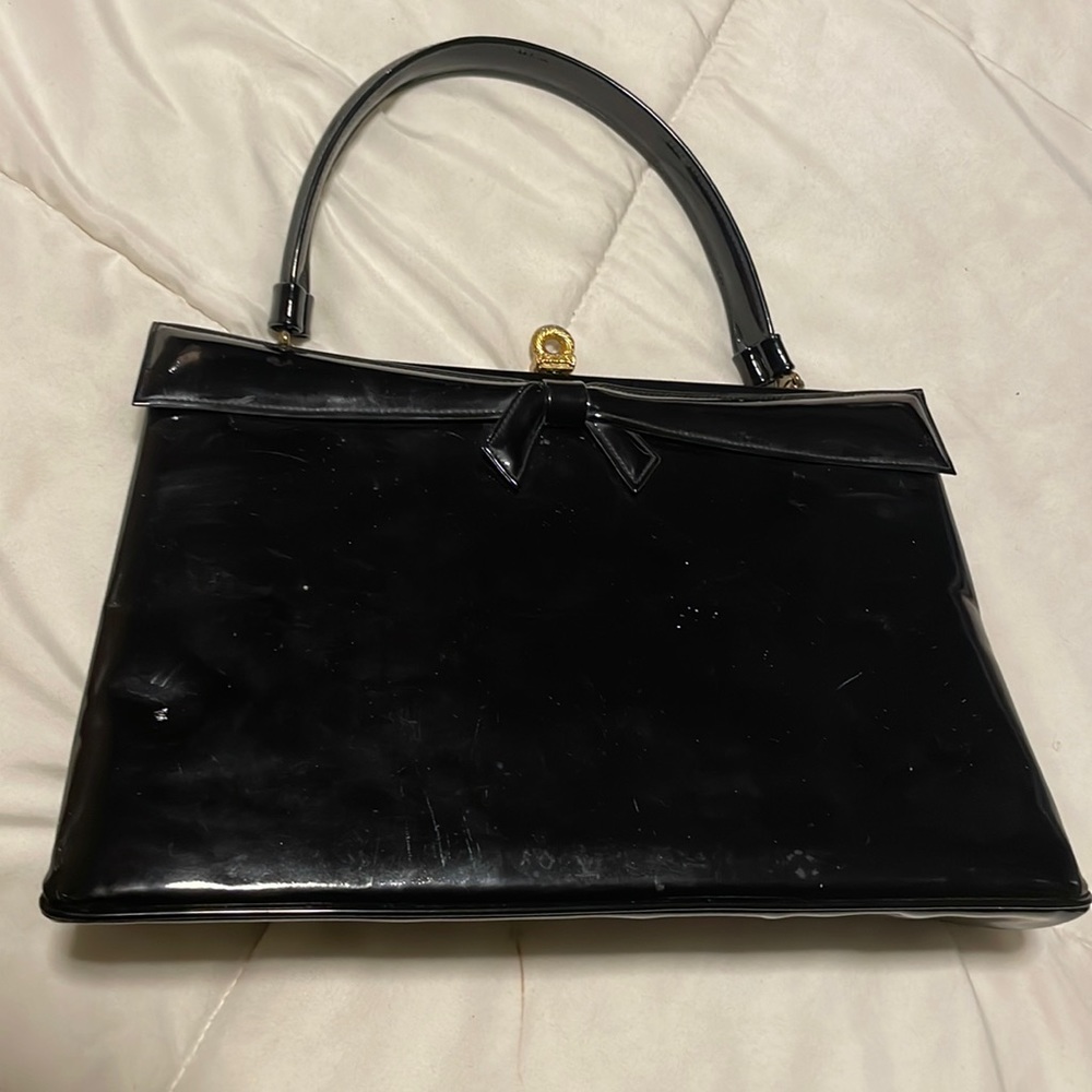Black patent leather handbag.